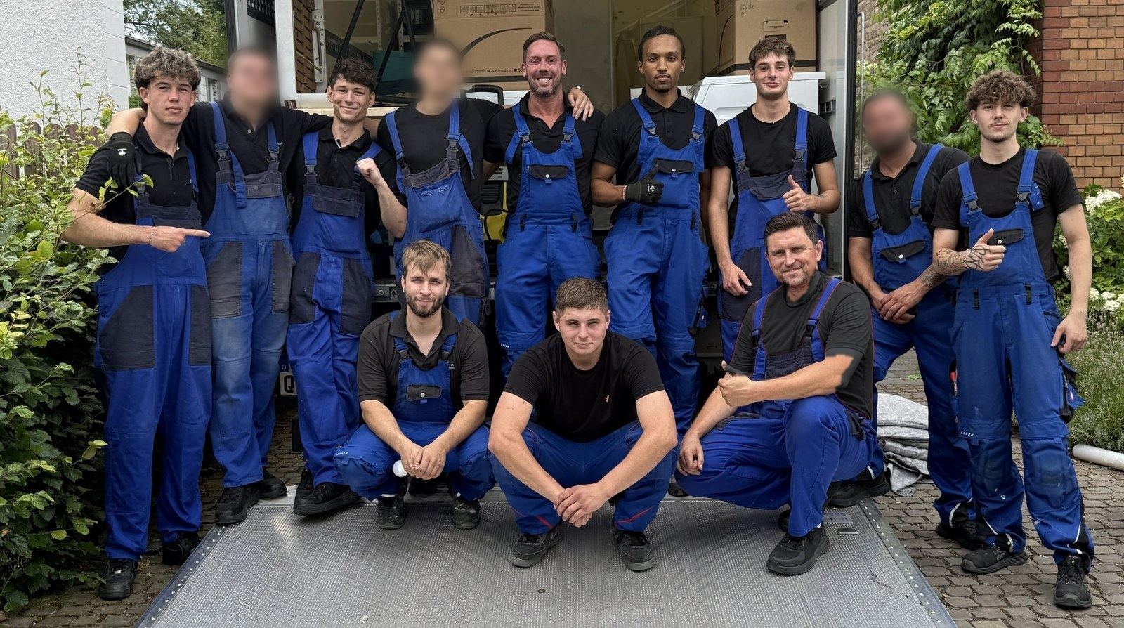 Unser Team vor der geöffneten Ladebordwand des Umzugswagens