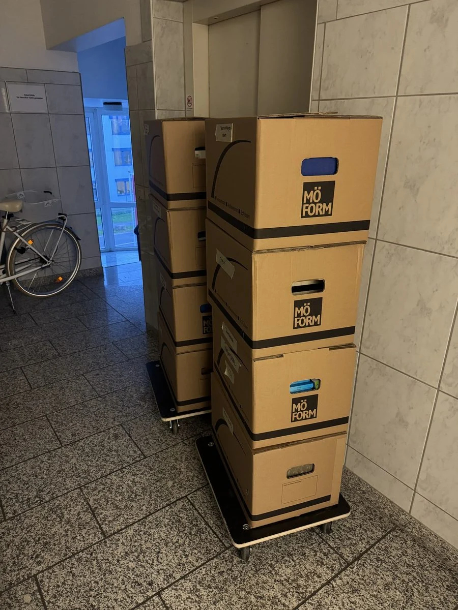 Ein Stapel spezieller Umzugskartons steht im Flur auf dem Fliesenboden